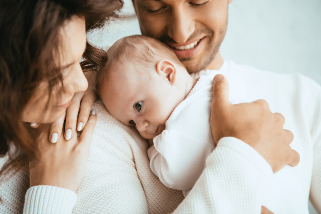 Contented parents gently holding their infant, an embodiment of the joy brought by successful IVF and acupuncture support.